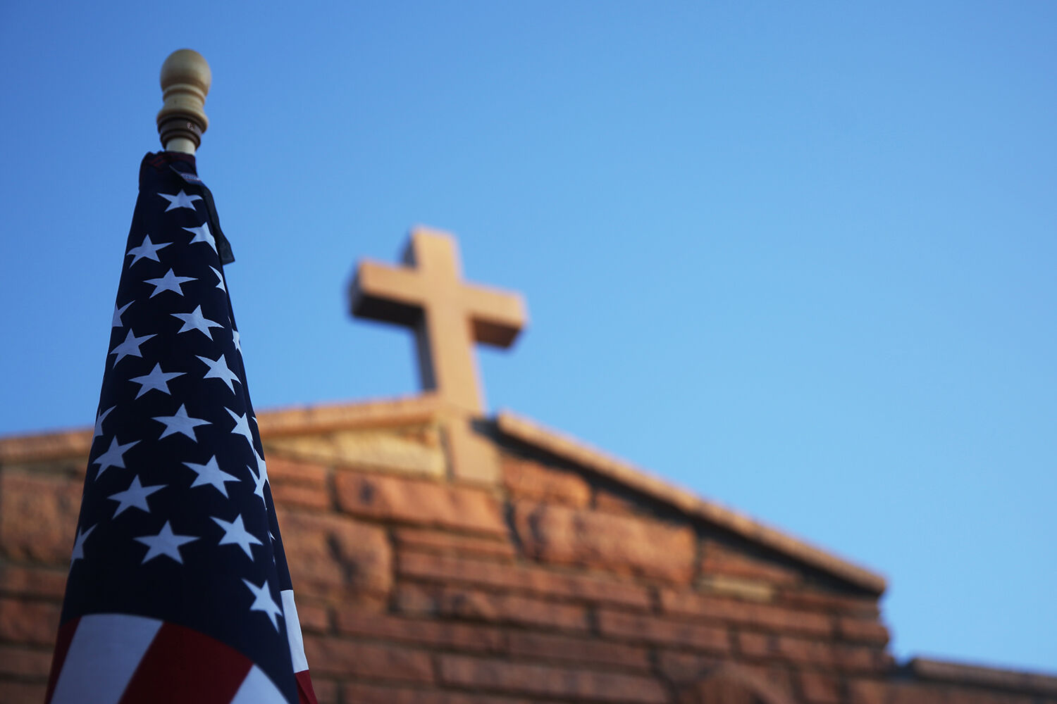 An American flag is put out front of the Catholic Church